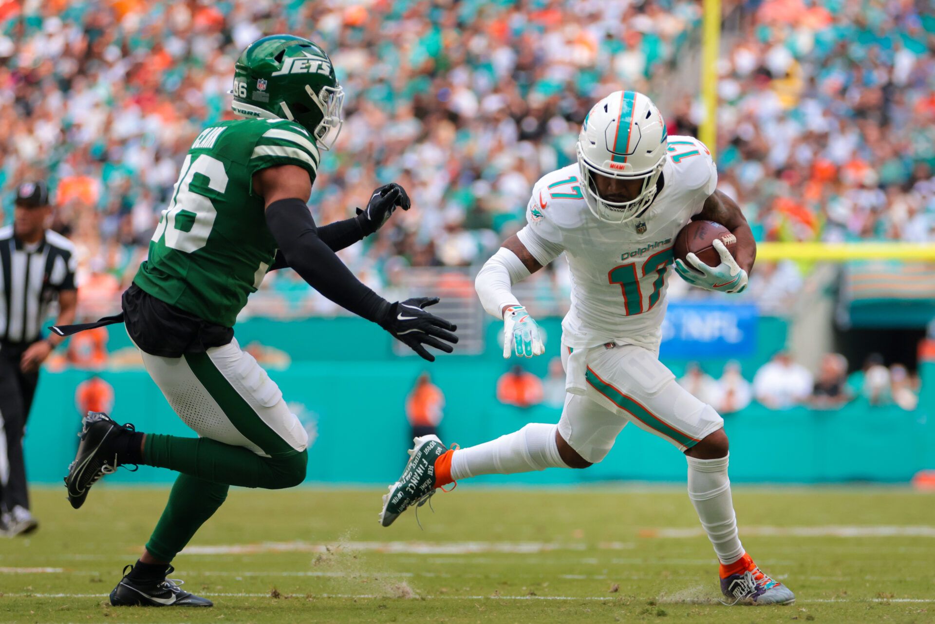Miami Dolphins wide receiver Jaylen Waddle (17) runs with the football past New York Jets safety Chuck Clark (36) during the second quarter at Hard Rock Stadium.