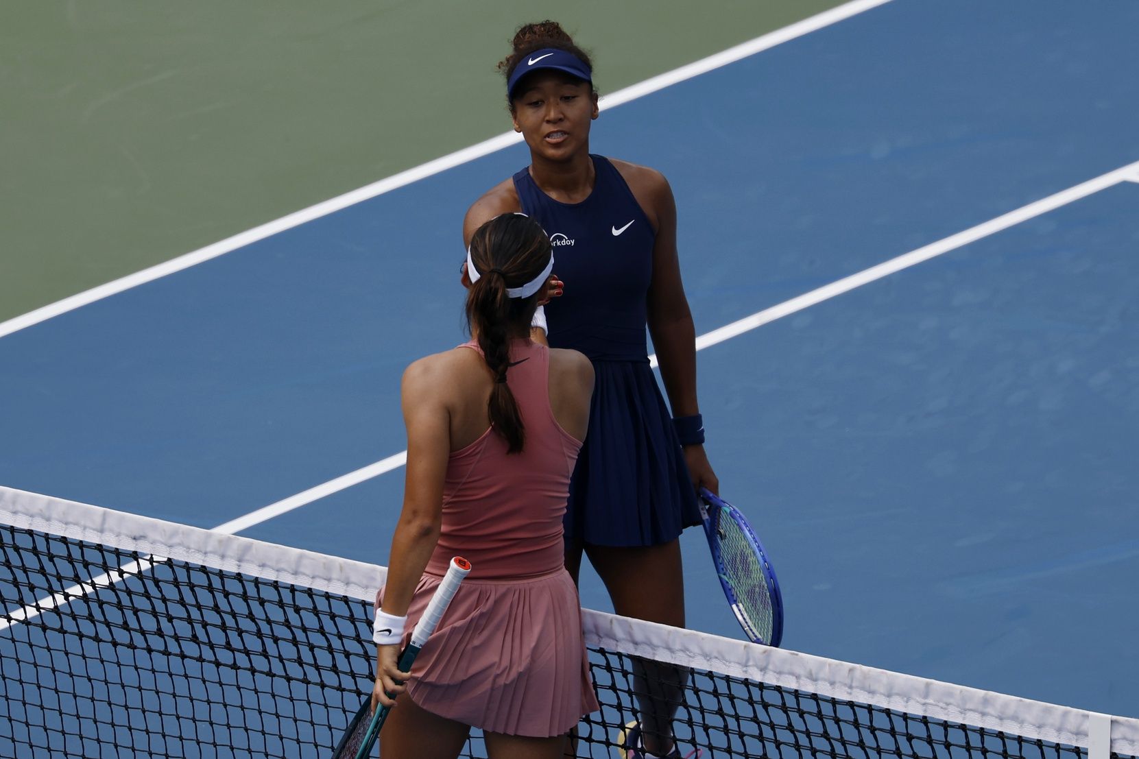 Emma Raducanu (GBR)(bottom) shakes hands with Naomi Osaka (JPN)(top) at the net after their women's singles match on day four of the Mubadala Citi DC Open at Rock Creek Park Tennis Center.