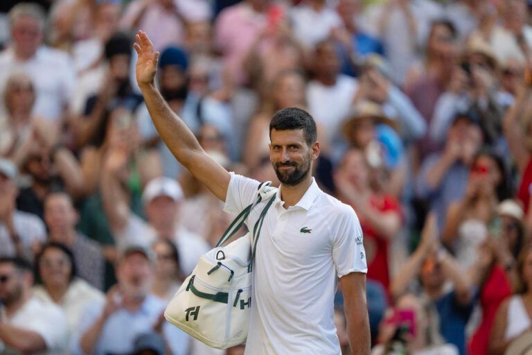 Novak Djokovic of Serbia leaves the court after losing his match to Jannik Sinner of Italy after their match on day 12 at All England Lawn Tennis and Croquet Club.