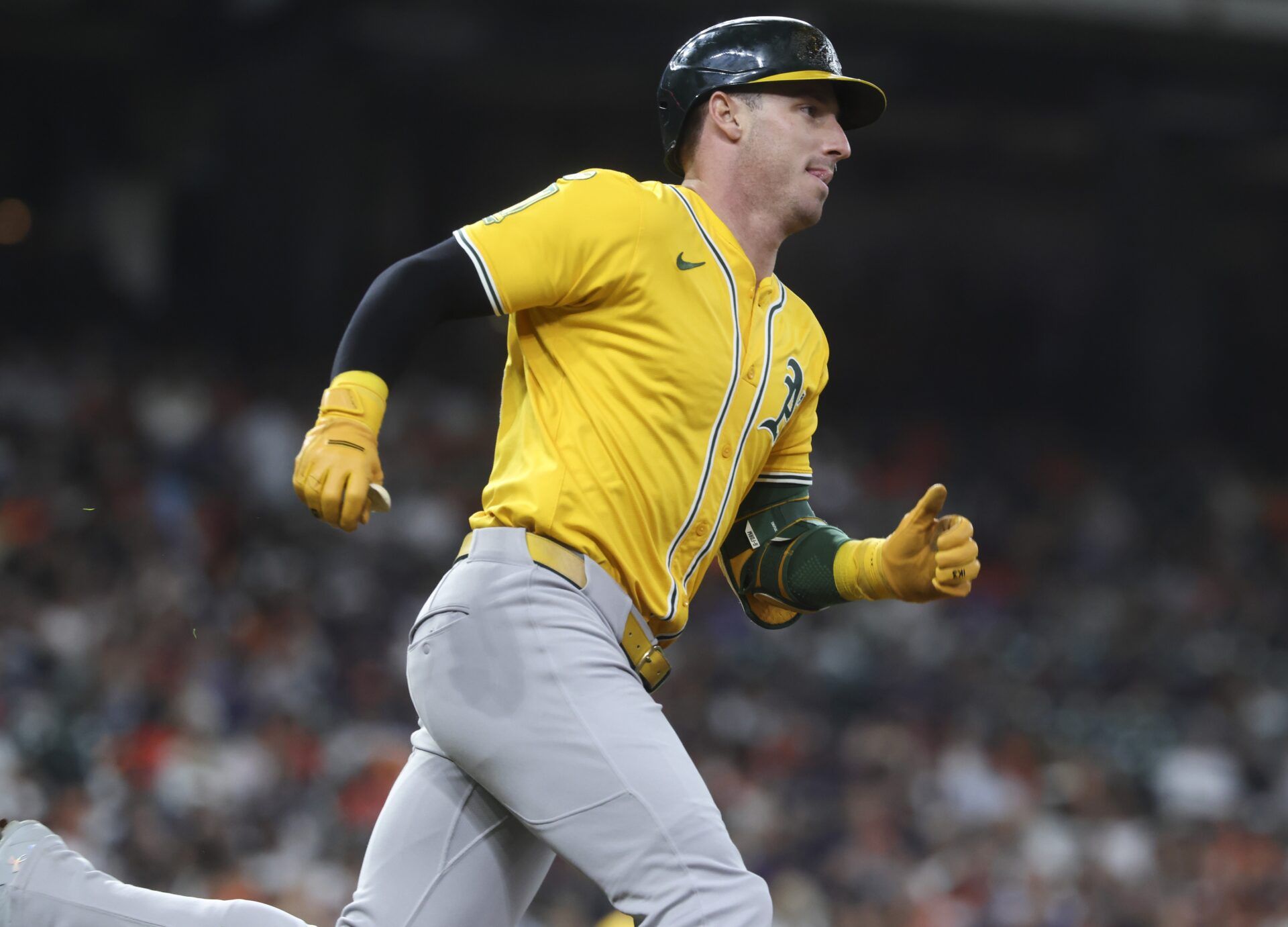 Athletics designated hitter Brent Rooker (25) runs to first base on a single during the third inning against the Houston Astros at Daikin Park.