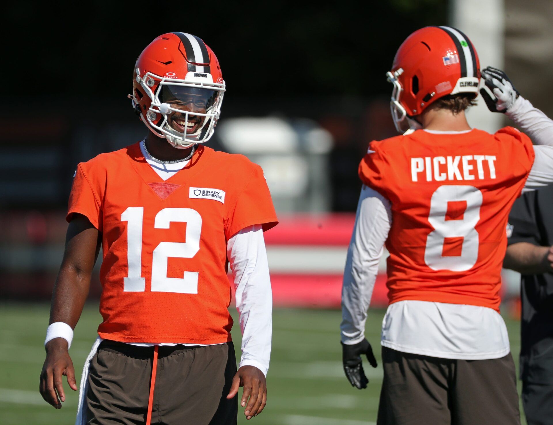 Cleveland Browns quarterback Shedeur Sanders (12) shares a laugh with quarterback Kenny Pickett (8) during NFL training camp practice at the Cleveland Browns training facility, Wednesday, July 23, 2025, in Berea, Ohio.
