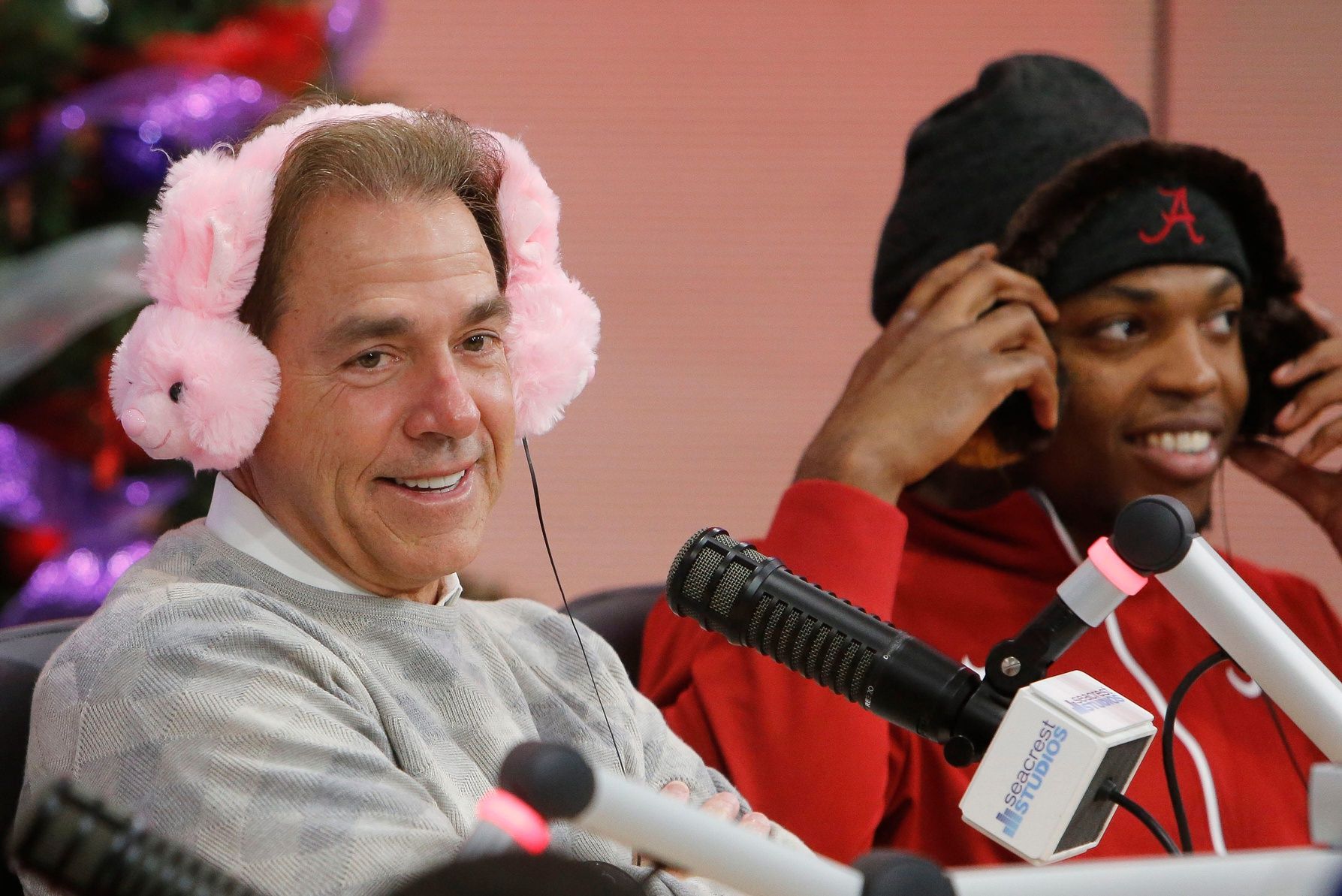 Coach Nick Saban wears headphones shaped like bunnies while doing a radio show for children during a visit to Children's Medical Center Dallas, Monday, December 28, 2015.  At right, Derrick Henry wears headphones with teddy bears on them.  Staff Photo | Gary Cosby Jr.

Crimson Tide Visit To Children S Medical Center Dallas