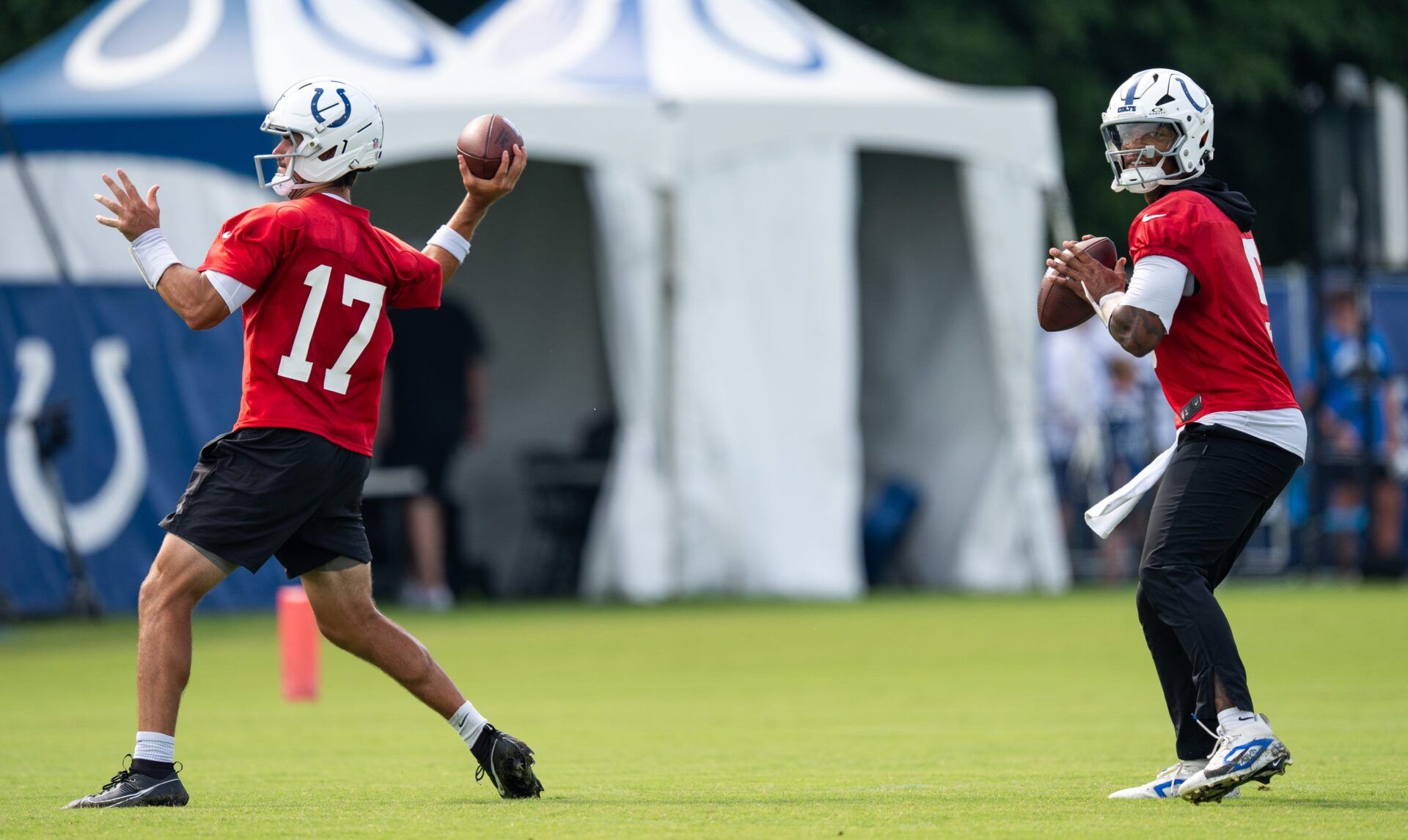 Indianapolis Colts quarterbacks Daniel Jones (17) and Anthony Richardson Sr. (5) pass Friday, July 25, 2025, during training camp held at Grand Park in Westfield.