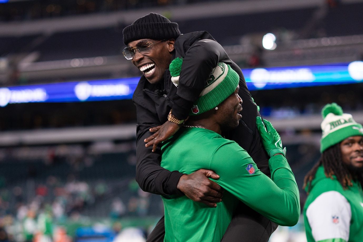 Former NFL player Chad Johnson jumps into the arms of Philadelphia Eagles wide receiver Julio Jones before a game against the Miami Dolphins at Lincoln Financial Field.