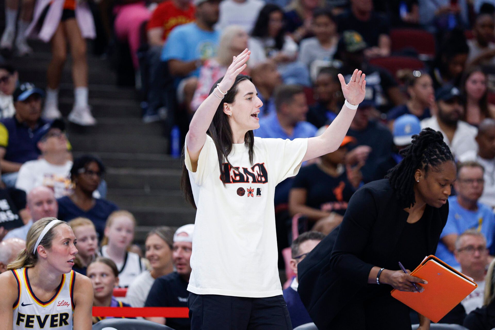 Injured Indiana Fever guard Caitlin Clark (22) reacts during the first half of a basketball game against the Chicago Sky at United Center.