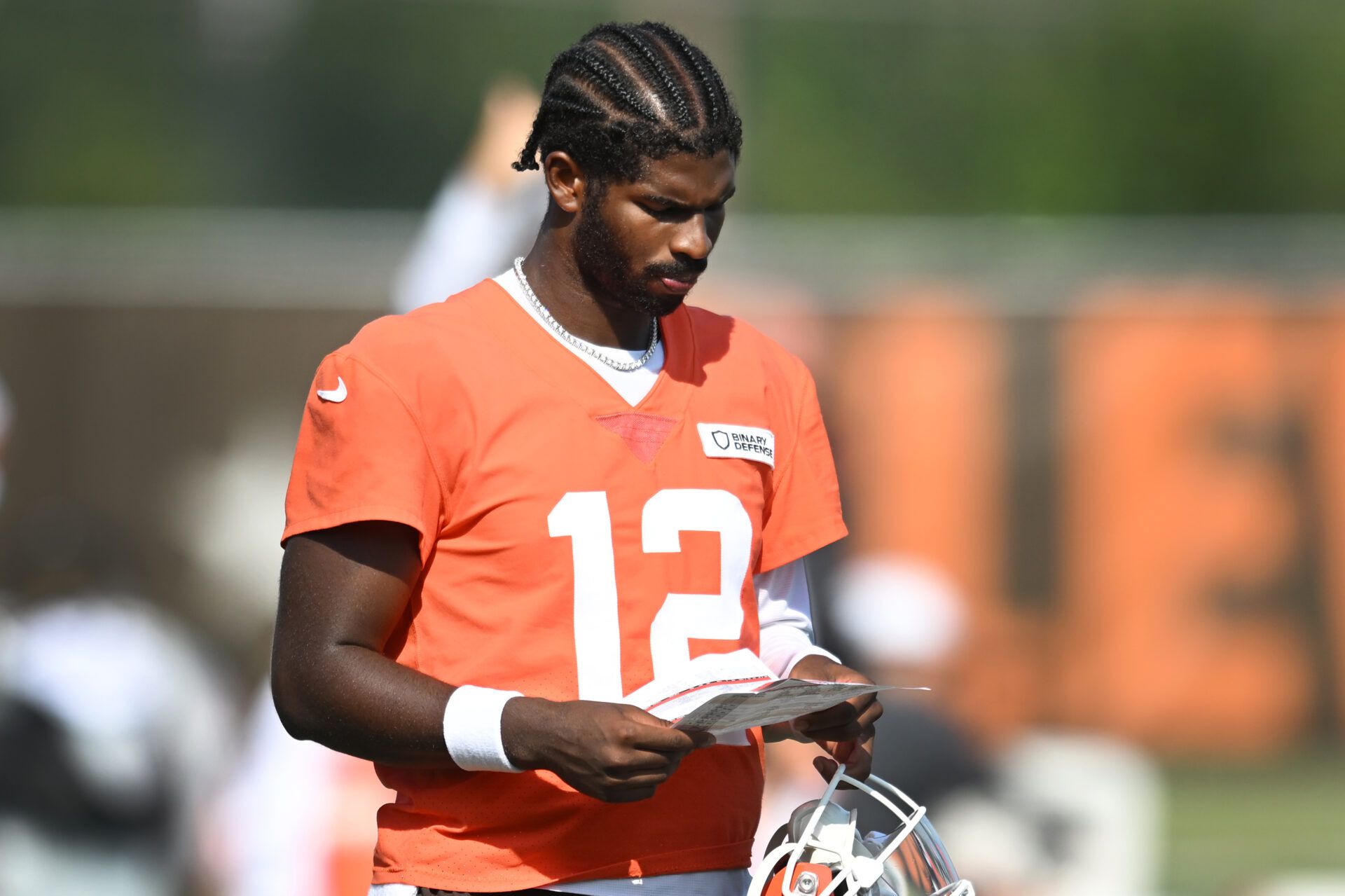 Cleveland Browns quarterback Shedeur Sanders (12) looks at a play sheet during training camp at CrossCountry Mortgage Campus.