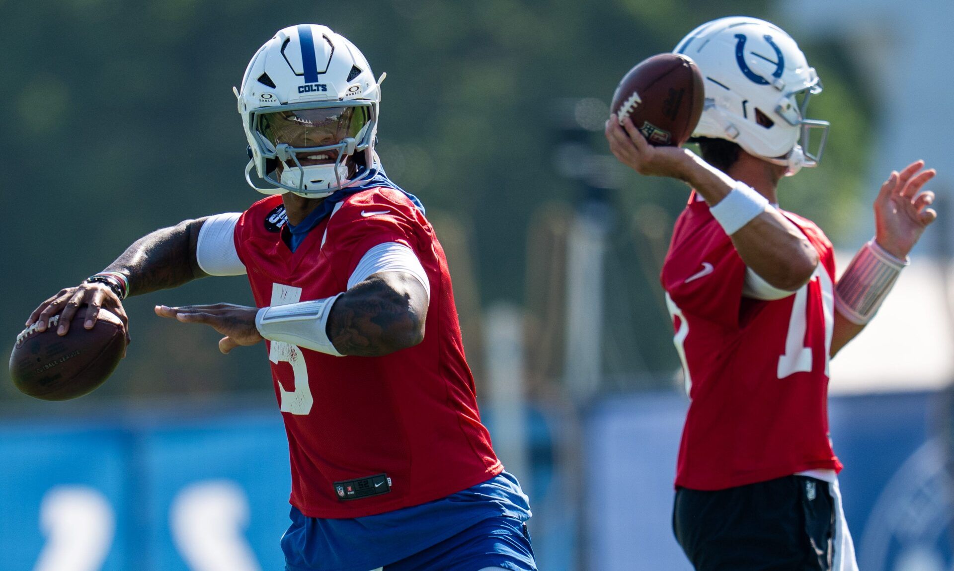 Indianapolis Colts quarterbacks Anthony Richardson Sr. (5) and Daniel Jones (17) pass Wednesday, July 23, 2025, during the first day of training camp held at Grand Park in Westfield.