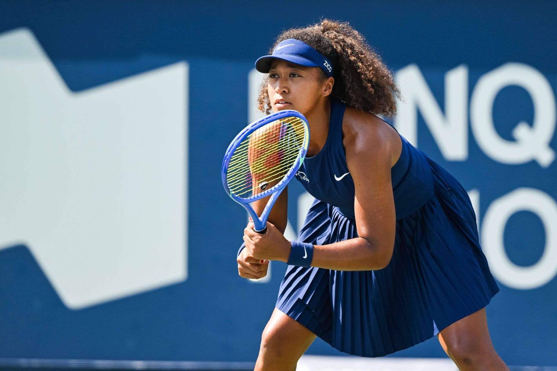 Naomi Osaka (JPN) waits for Ariana Arseneault (CAN) to serve the ball  in first round play at IGA Stadium.