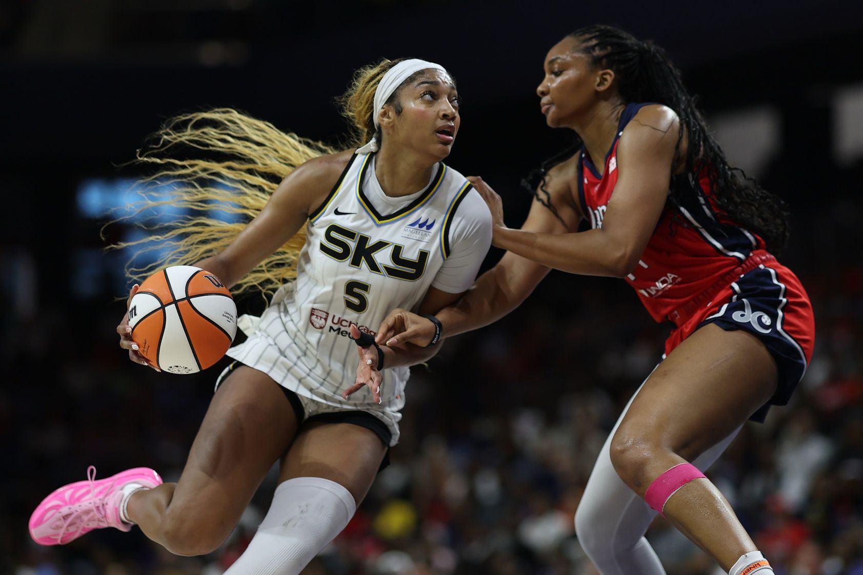 Chicago Sky forward Angel Reese (5) drives to the basket as Washington Mystics forward Kiki Iriafen (44) defends in the first half at CareFirst Arena.