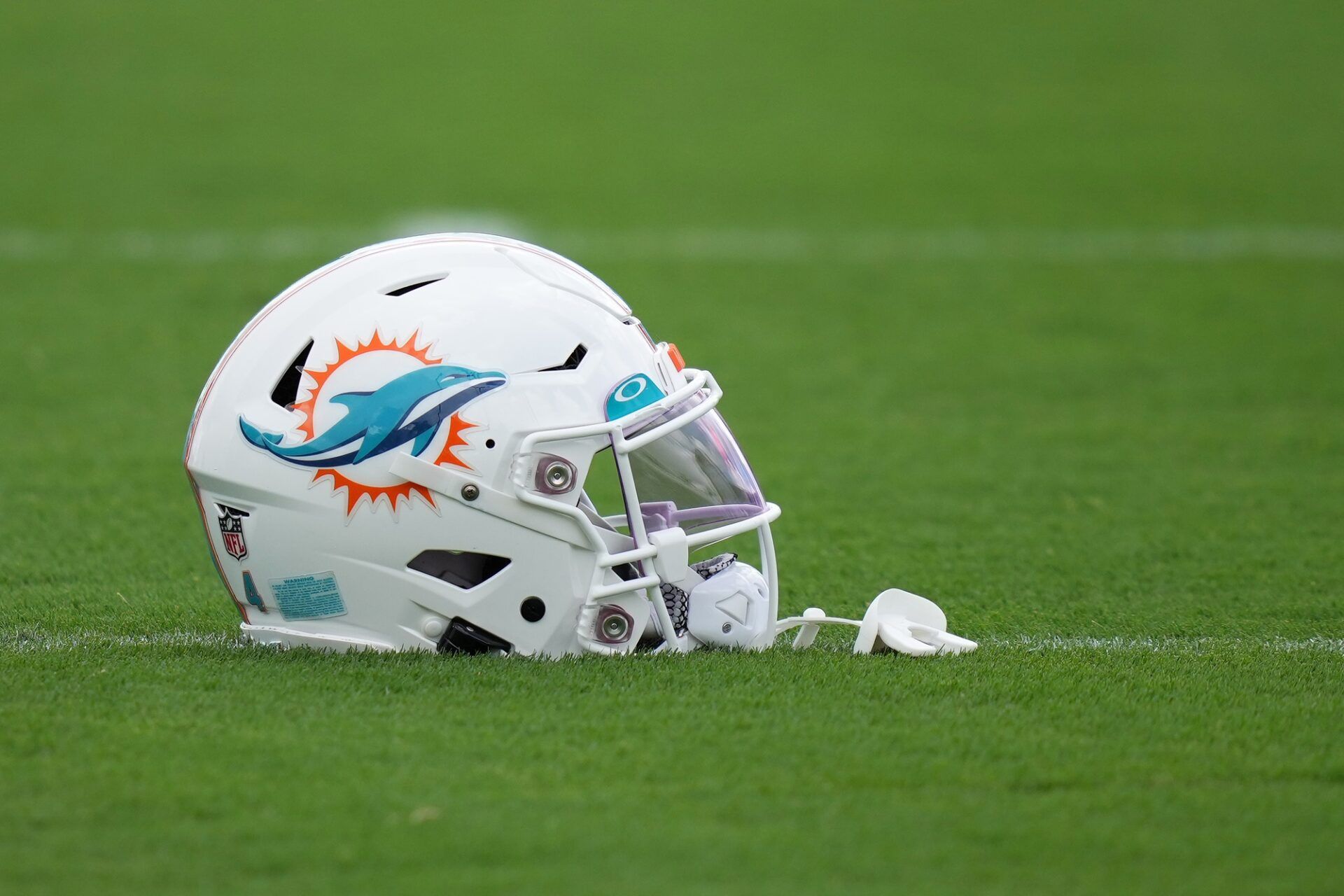 A general view of a Miami Dolphins helmet on the field during training camp at Baptist Health Training Complex.