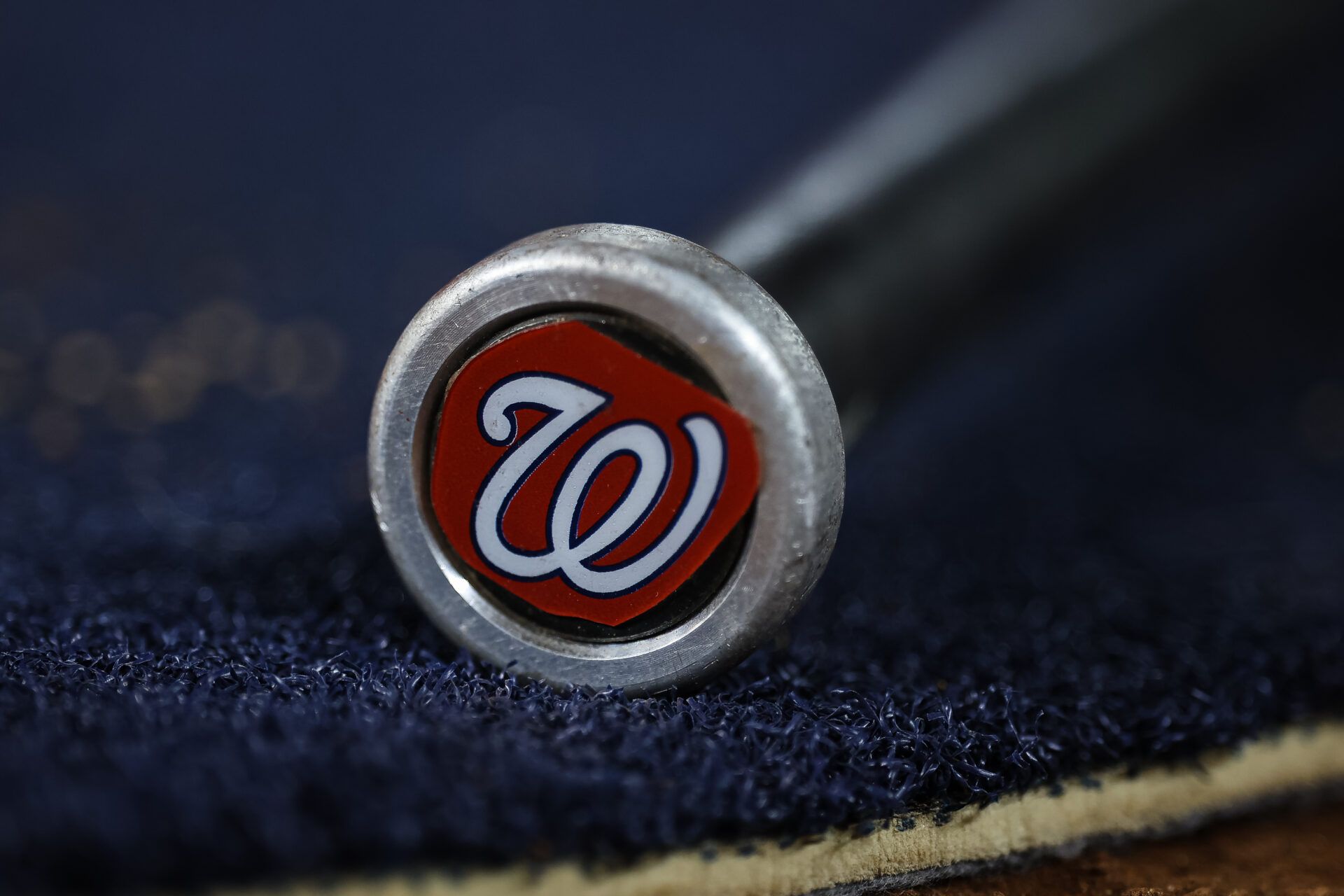 A detailed view of the Washington Nationals logo on a weighted bat during the seventh inning of the game between the Washington Nationals and the New York Mets at Nationals Park.