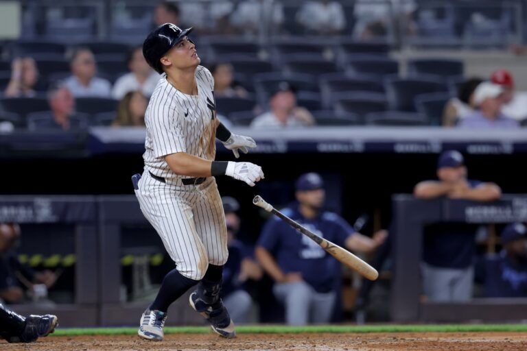 New York Yankees shortstop Anthony Volpe (11) watches his solo home run against the Tampa Bay Rays during the eighth inning at Yankee Stadium.