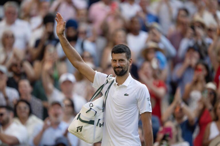 Novak Djokovic of Serbia leaves the court after losing his match to Jannik Sinner of Italy after their match on day 12 at All England Lawn Tennis and Croquet Club.