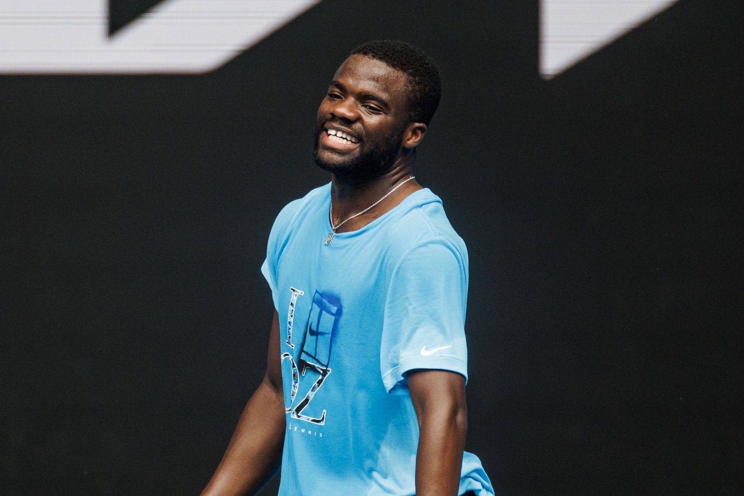 Frances Tiafoe of the United States laughs during a practice session   at Melbourne Park.