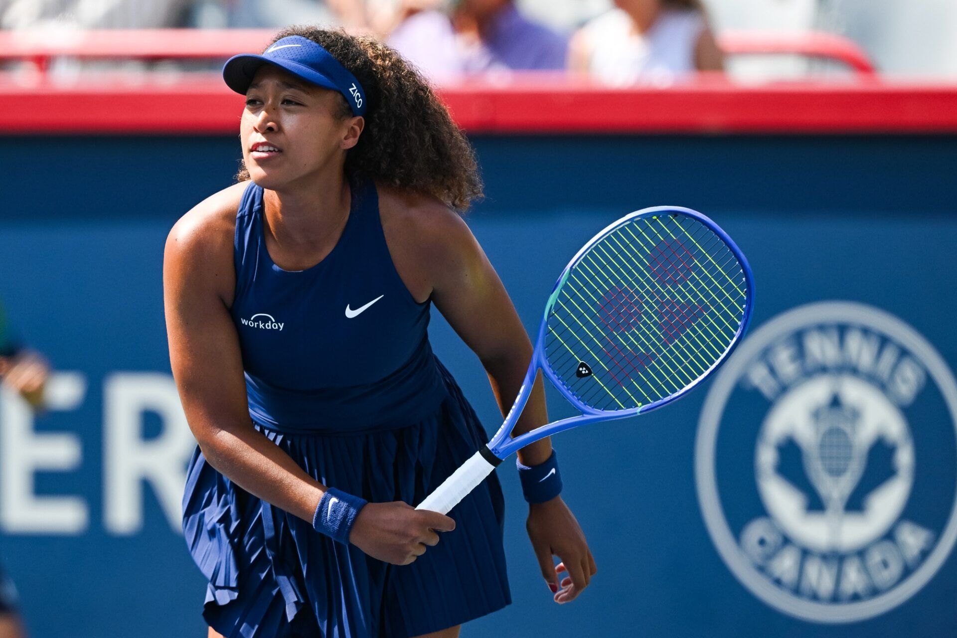 Naomi Osaka (JPN) tracks her service return against Ariana Arseneault (CAN) in first round play at IGA Stadium.