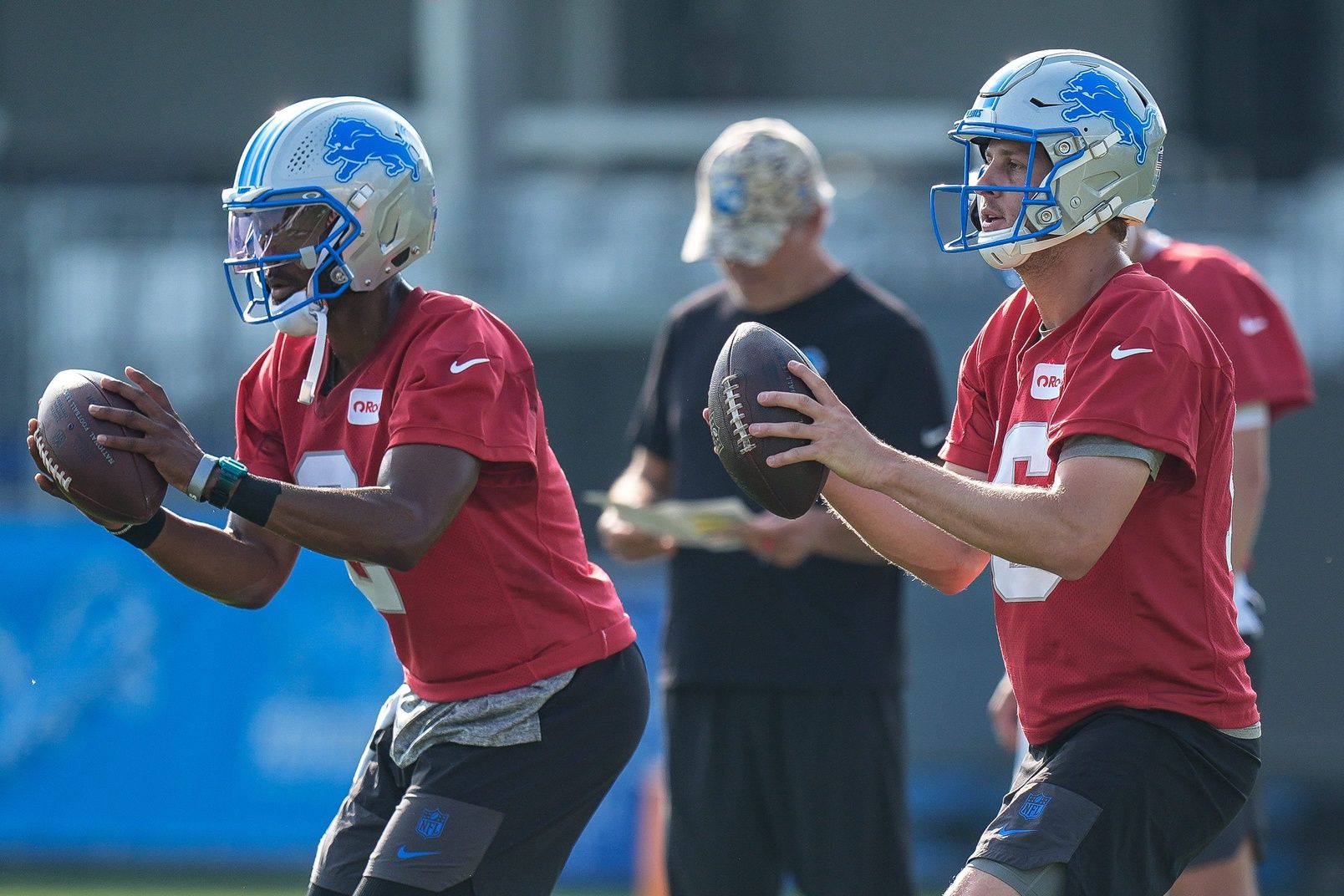 Detroit Lions quarterback Jared Goff (16), right, and quarterback Hendon Hooker (2) practice during training camp at Meijer Performance Center in Allen Park on Thursday, July 24, 2025.