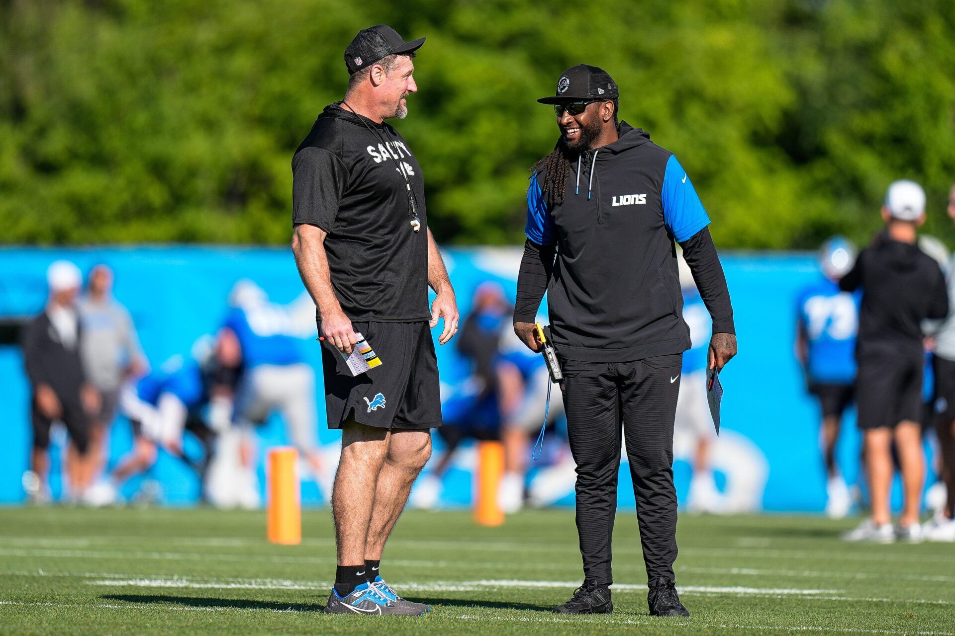 Detroit Lions head coach Dan Campbell talks to defensive coordinator Kelvin Sheppard at practice during training camp at Meijer Performance Center in Allen Park on Tuesday, July 22, 2025.