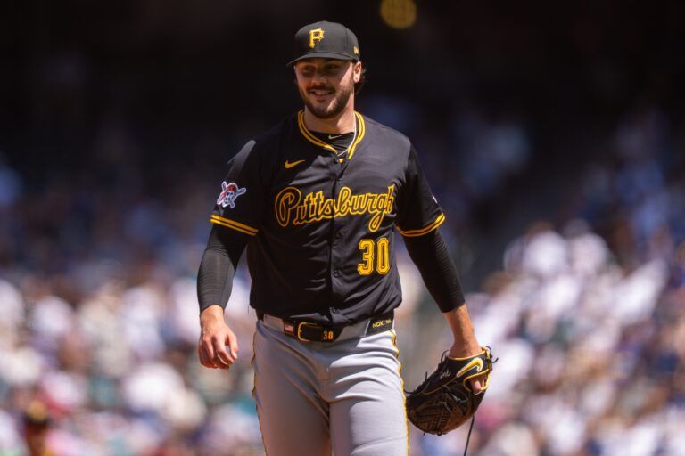 Pittsburgh Pirates starting pitcher Paul Skenes (30) smiles as he walks off the field during the third inning at T-Mobile Park.