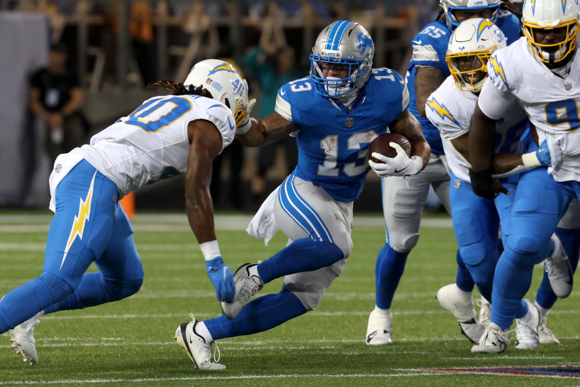 Detroit Lions running back Craig Reynolds (13) runs against Los Angeles Chargers safety Kendall Williamson (40) in the second quarter at Tom Benson Hall of Fame Stadium.