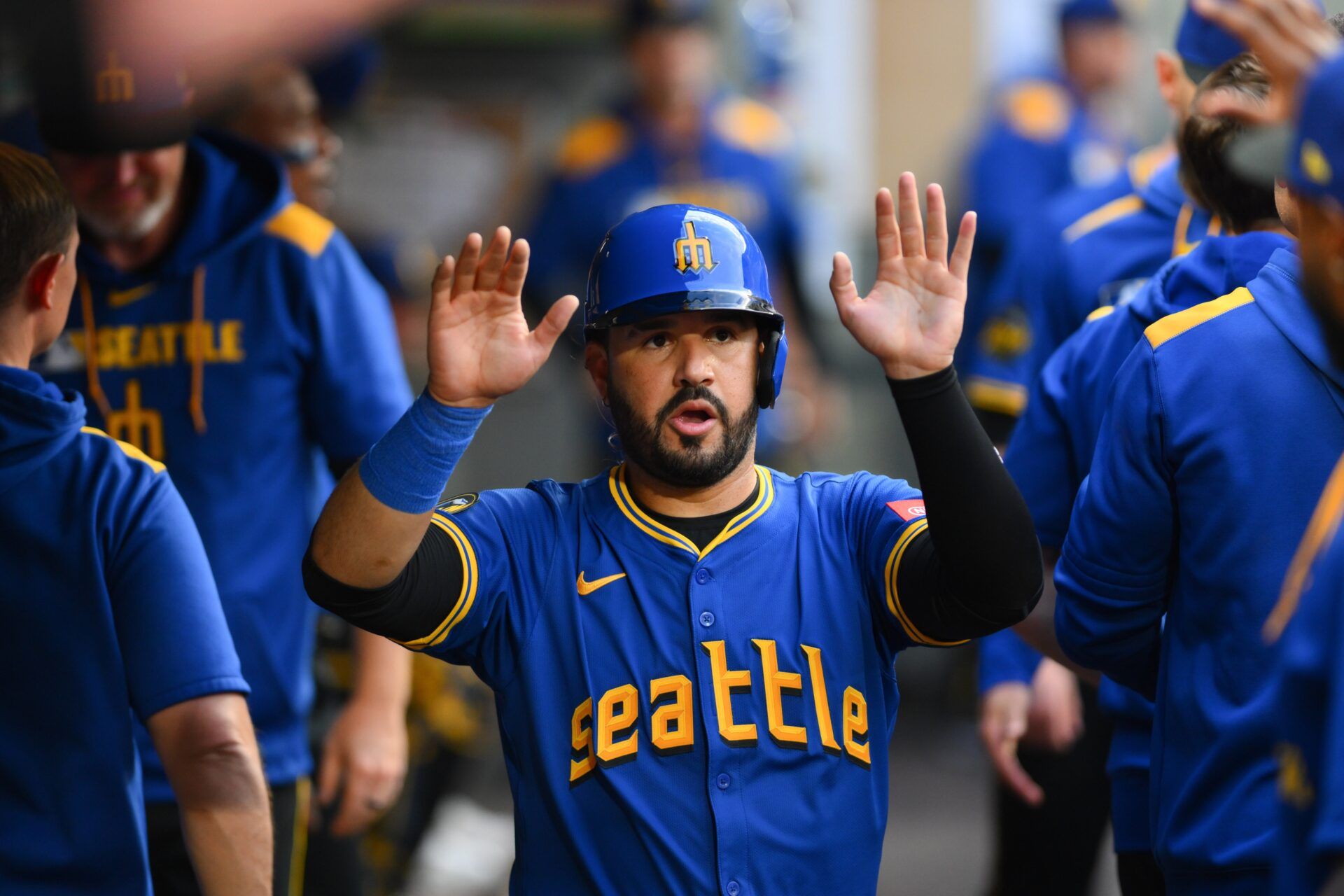 Seattle Mariners third baseman Eugenio Suarez (28) celebrates in the dugout after scoring a run against the Texas Rangers during the fourth inning at T-Mobile Park.