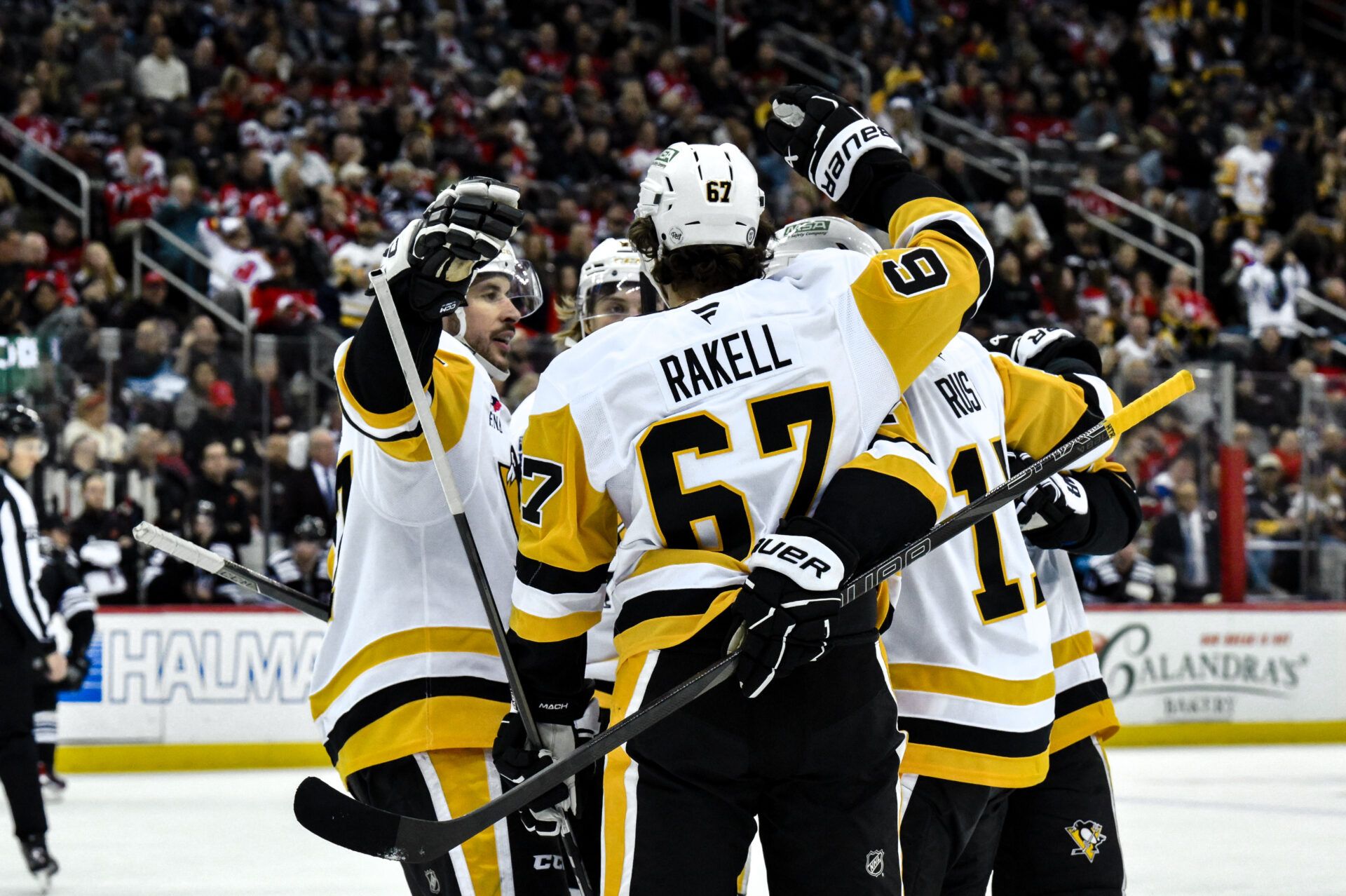 Pittsburgh Penguins right wing Bryan Rust (17) celebrates with teammates after scoring a goal against the New Jersey Devils during the third period at Prudential Center.