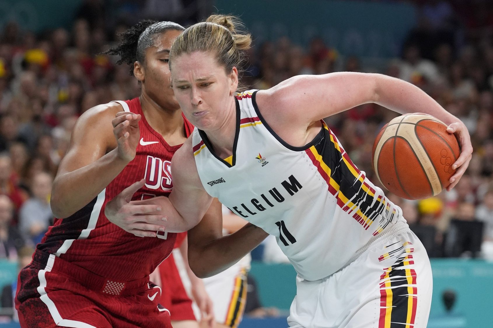 Belgium power forward Emma Meesseman (11) controls the ball against United States power forward Alyssa Thomas (14) in the second half in a women’s group stage game during the Paris 2024 Olympic Summer Games at Stade Pierre-Mauroy.