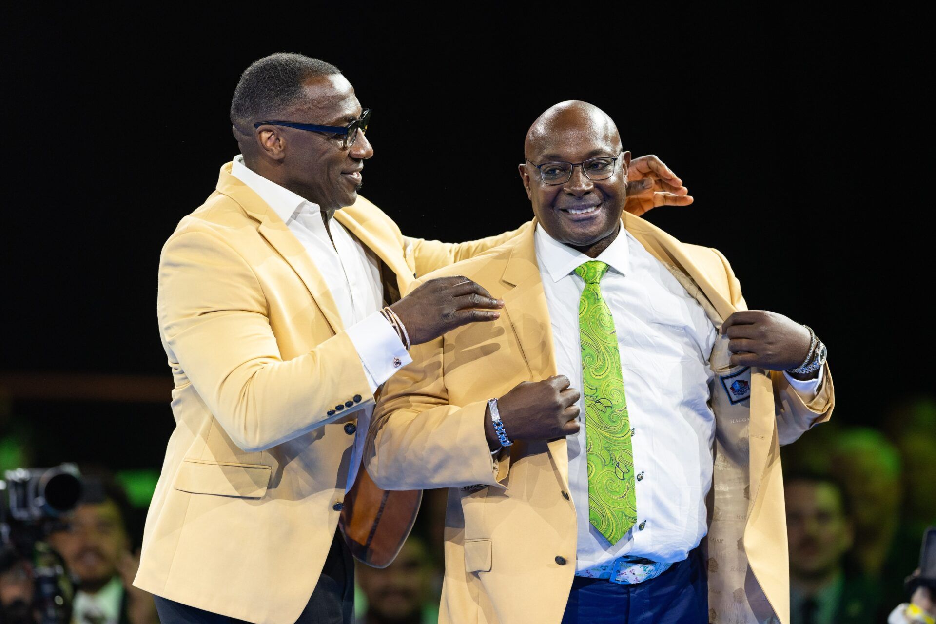 Shannon Sharpe presents his brother Sterling Sharpe with a gold jacket at the 2025 Pro Football Hall of Fame Enshrinees’ Gold Jacket Dinner at Canton Memorial Civic Center.