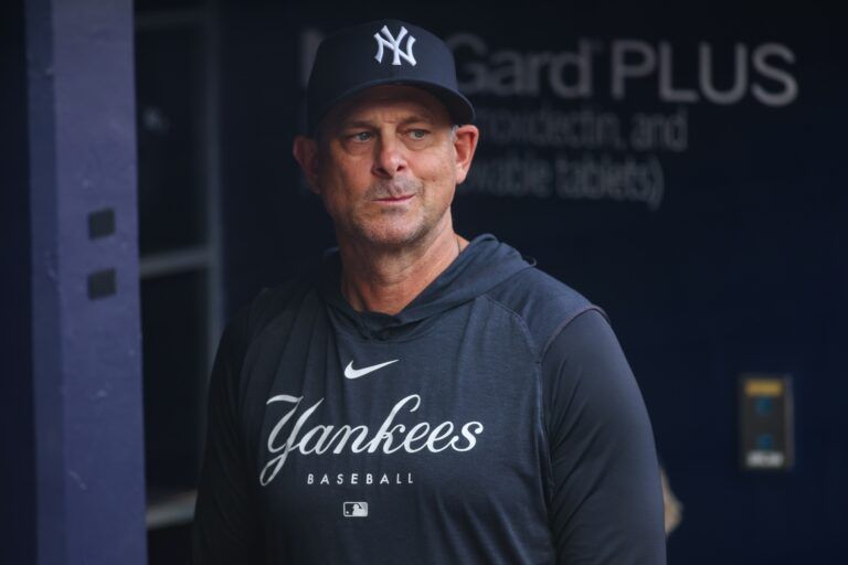 New York Yankees manager Aaron Boone (17) in the dugout before a game against the Atlanta Braves at Truist Park.
