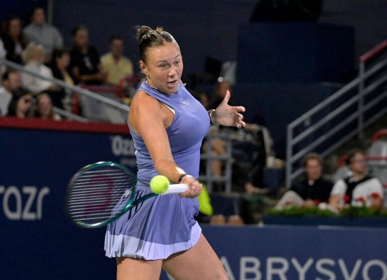 Amanda Anisimova (USA) returns the ball against Emma Raducanu (GBR) in third round play at IGA Stadium.