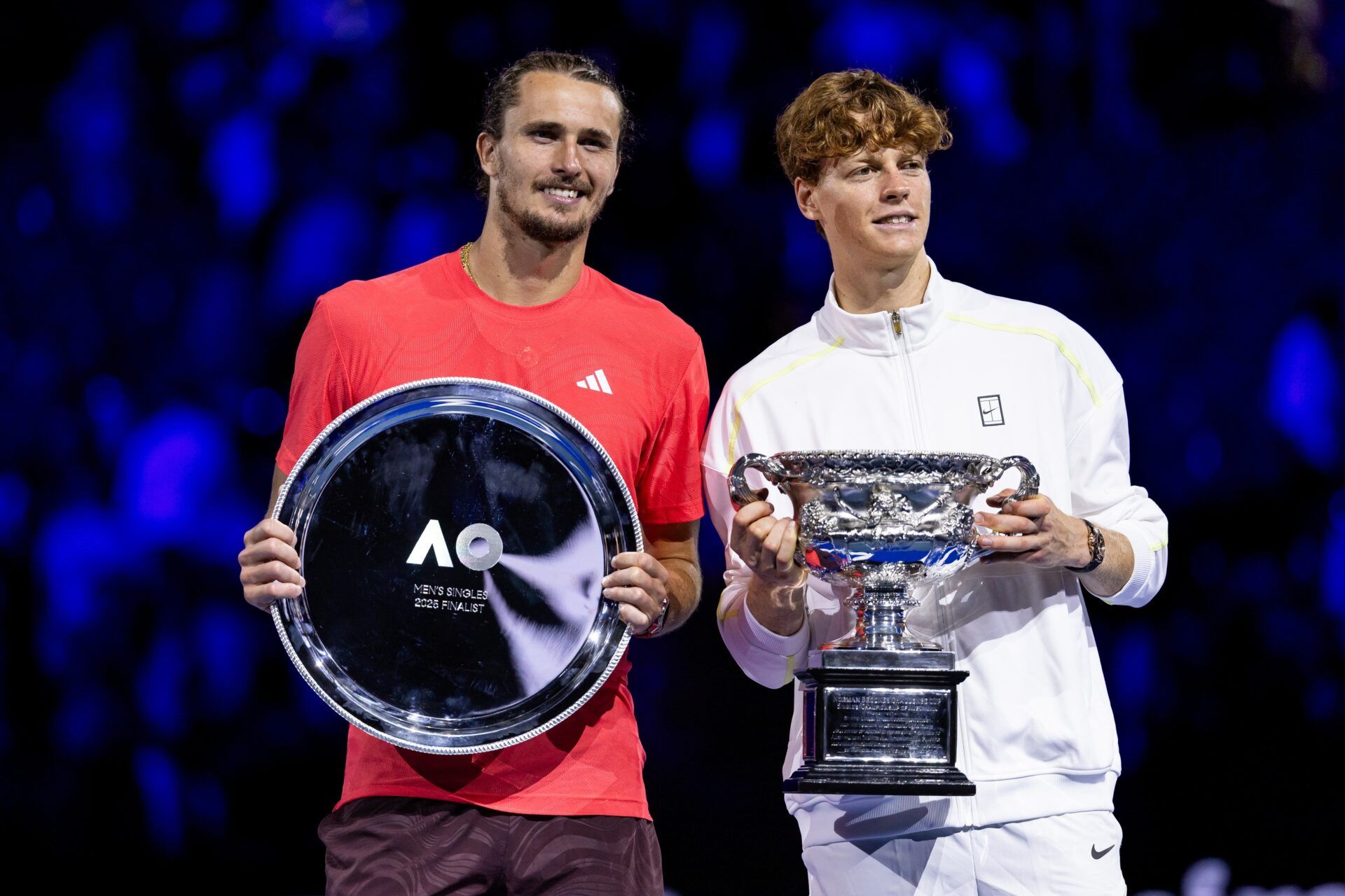 Jannik Sinner of Italy and Alexander Zverev of Germany share a moment during the prize presentation of the men's single final at the 2025 Australian Open at Melbourne Park.