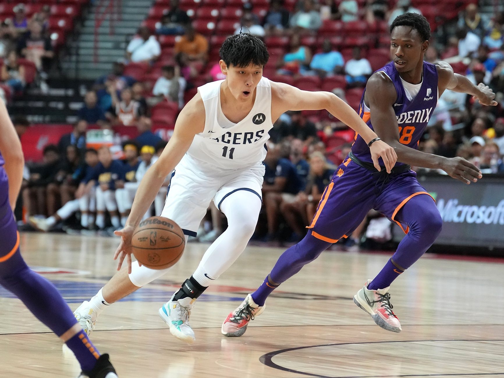 Indiana Pacers forward Fanbo Zeng (11) dribbles against Phoenix Suns guard Brancou Badio (28) during an NBA Summer League game at Thomas & Mack Center.
