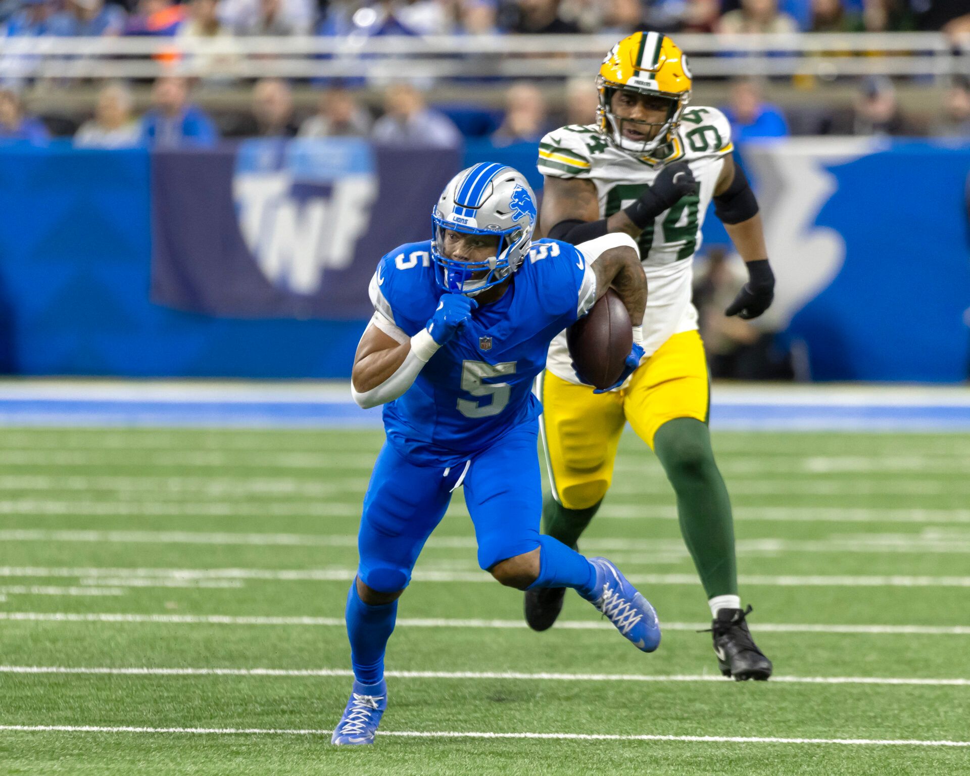 Detroit Lions running back David Montgomery (5) runs with the ball during the first half while chased by Green Bay Packers defensive end Karl Brooks (94) at Ford Field.