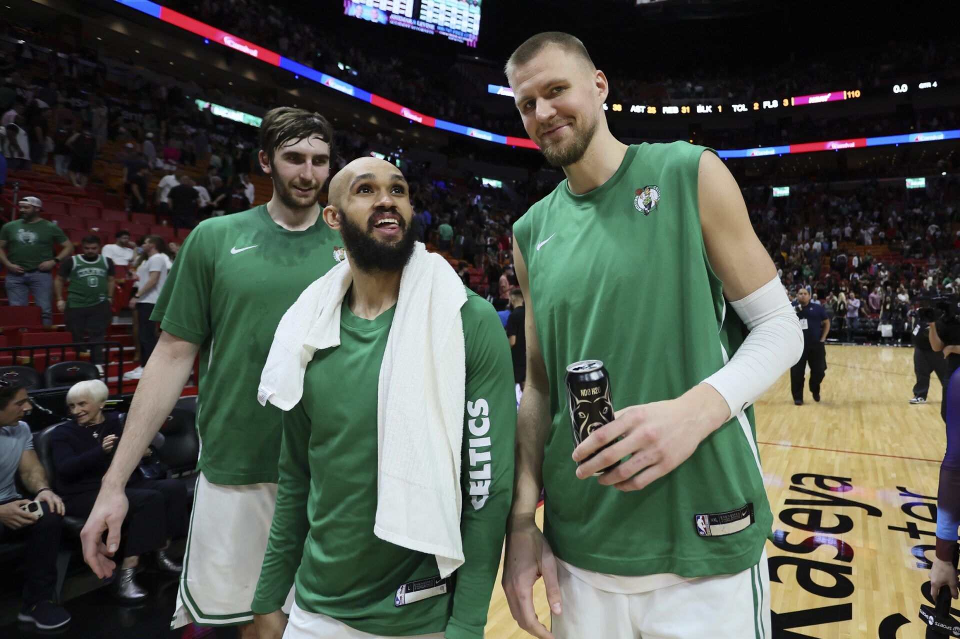 Boston Celtics center Kristaps Porzingis (right), guard Derrick White (center) and center Luke Kornet (left) look on after the game against the Miami Heat at Kaseya Center.