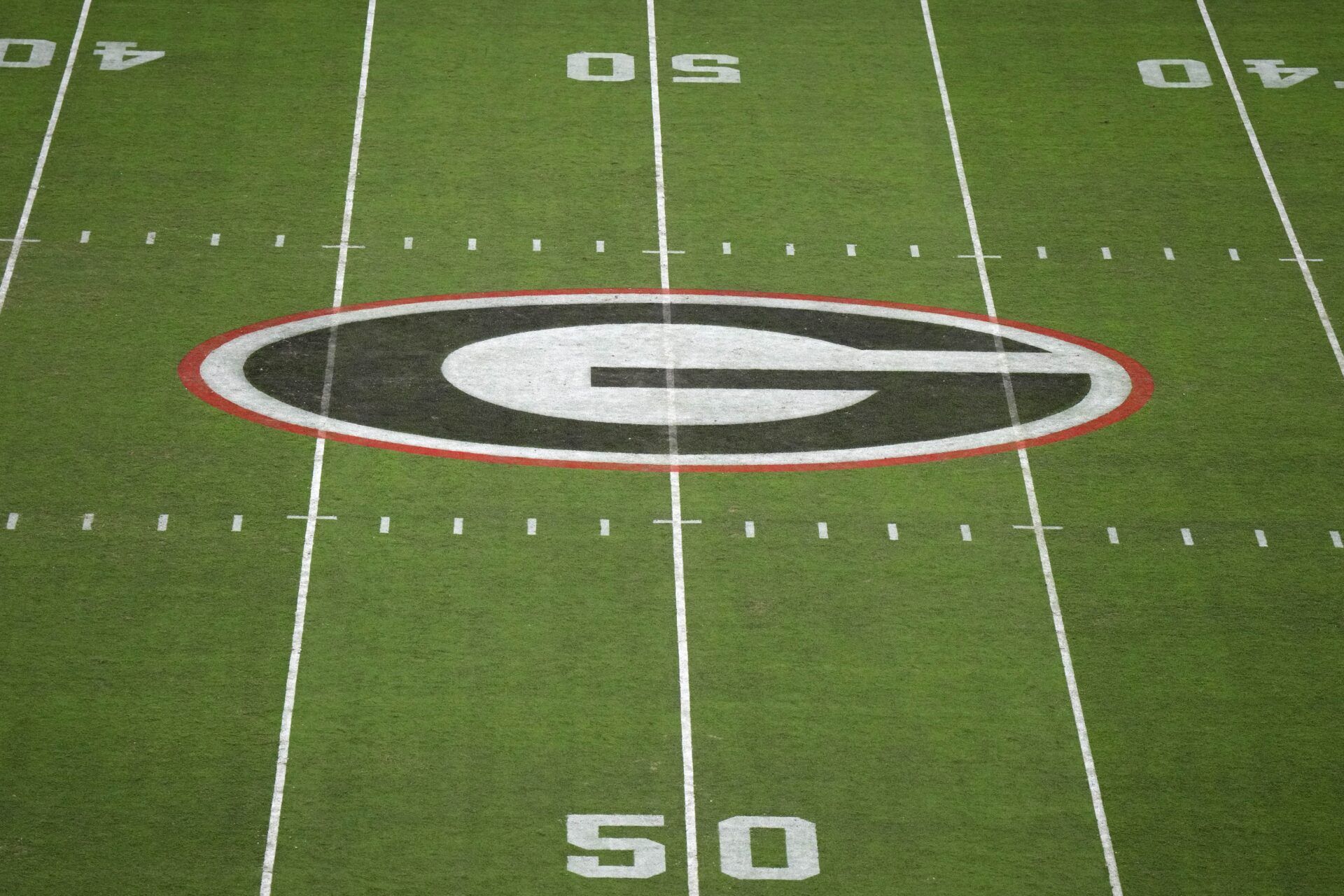 The Georgia Bulldogs logo at midfield at Sanford Stadium.