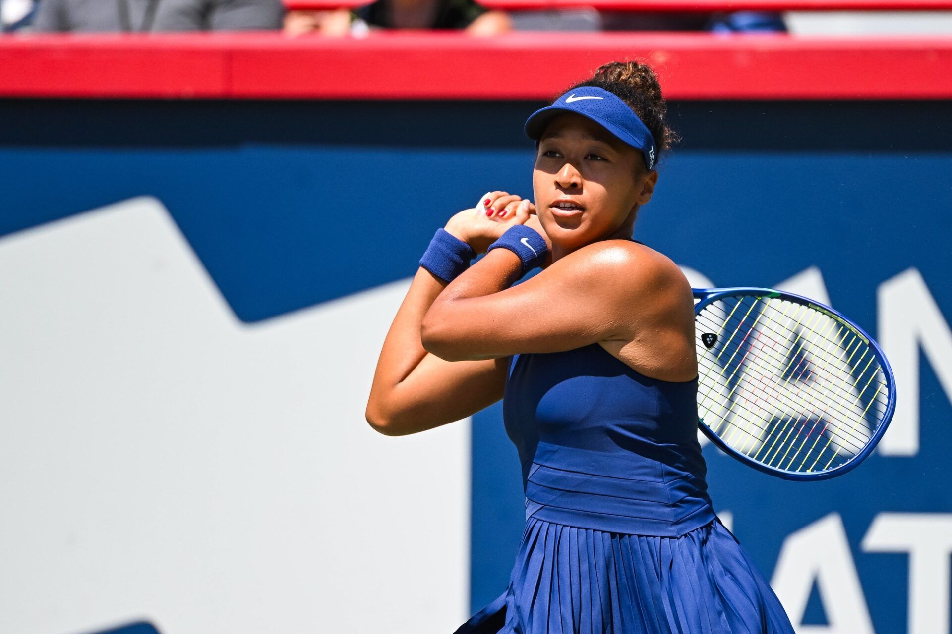 Naomi Osaka (JPN) returns the ball to Jelena Ostapenko (LAT) in third round play at IGA Stadium.