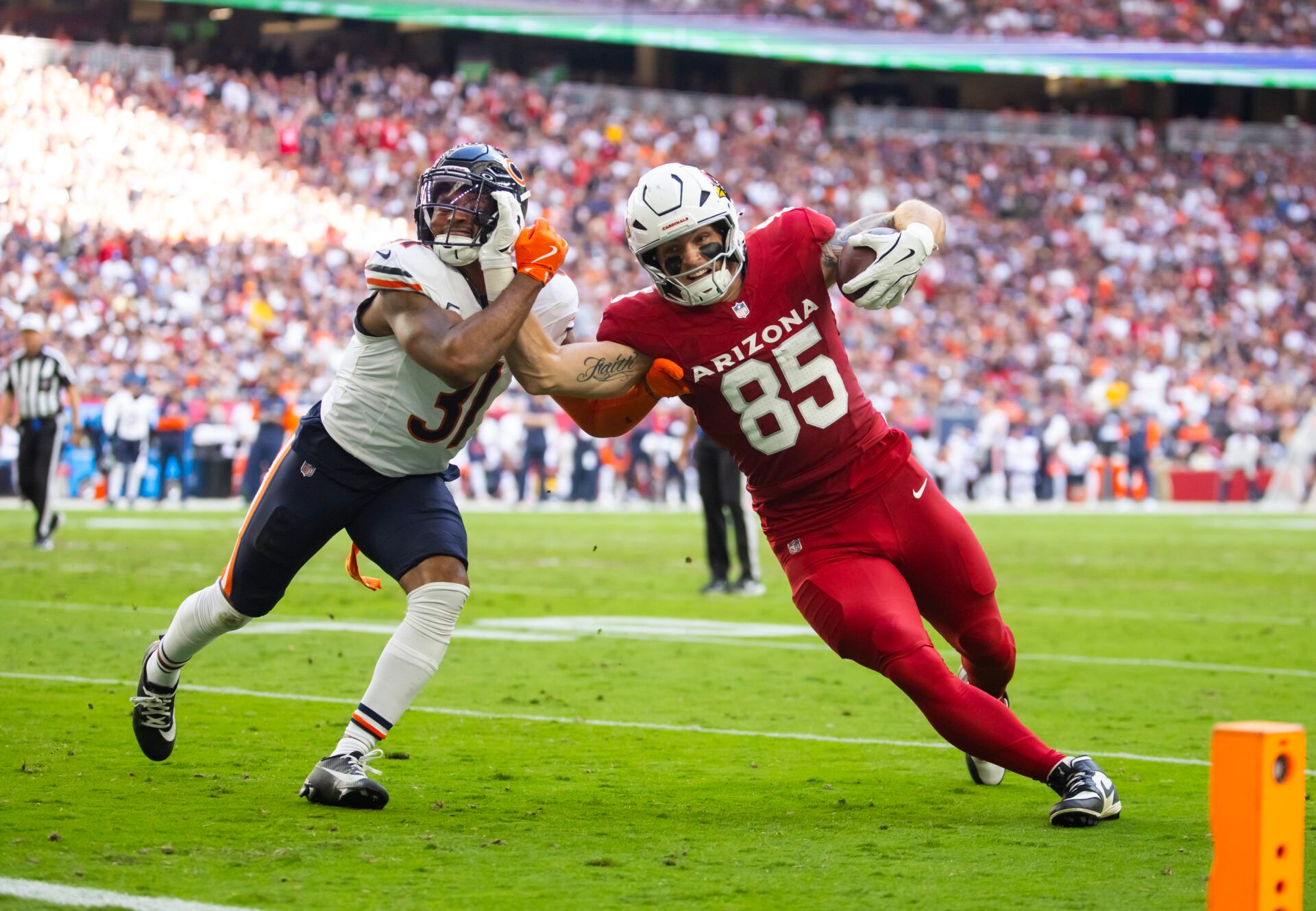 Arizona Cardinals tight end Trey McBride (85) scores a touchdown against Chicago Bears safety Kevin Byard III (31) in the first half at State Farm Stadium.