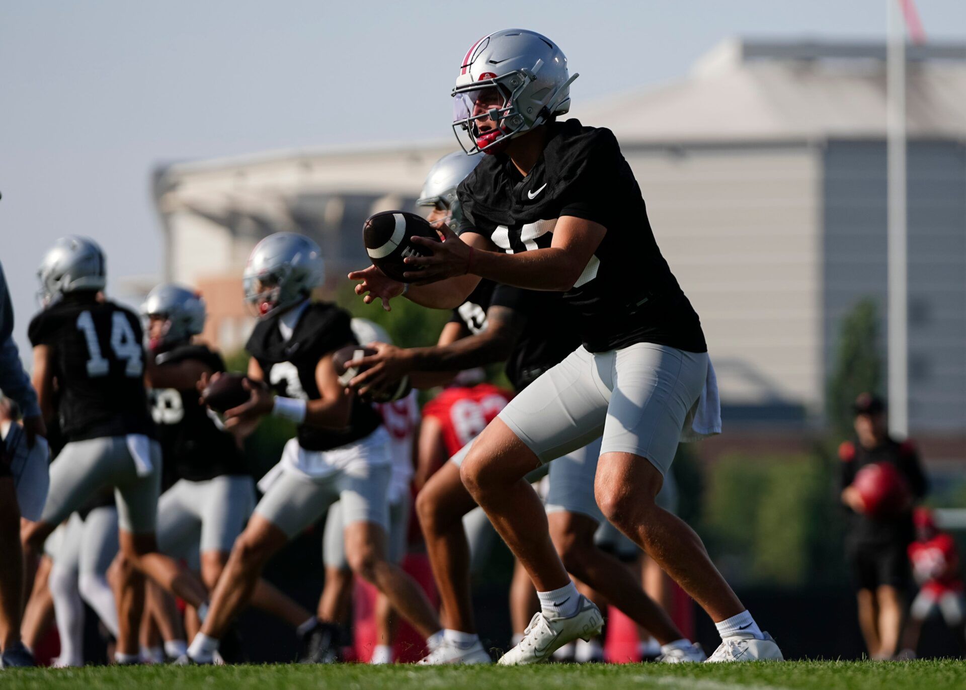 Ohio State Buckeyes quarterback Julian Sayin (10) takes a snap during football training camp at the Woody Hayes Athletic Center on Aug. 1, 2025.