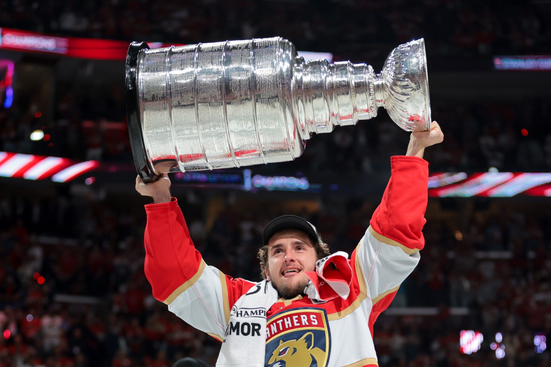 Florida Panthers right wing Mackie Samoskevich (25) hoists the Stanley Cup after winning game six of the 2025 Stanley Cup Final against the Edmonton Oilers at Amerant Bank Arena.