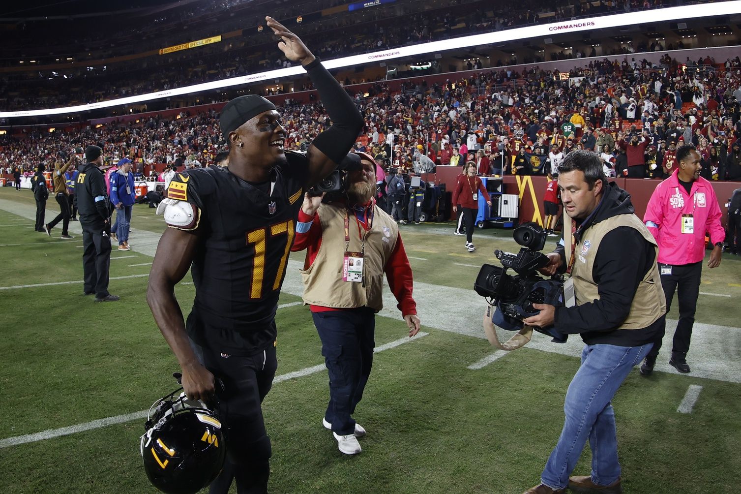Washington Commanders wide receiver Terry McLaurin (17) celebrates while leaving the field after the Commanders' game against the Chicago Bears  at Northwest Stadium.