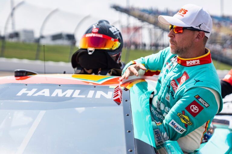 Denny Hamlin (11) enters his car during NASCAR Cup Series qualifying on Aug. 2, 2025, at Iowa Speedway in Newton, Iowa. Chase Briscoe (19) qualified on the pole.