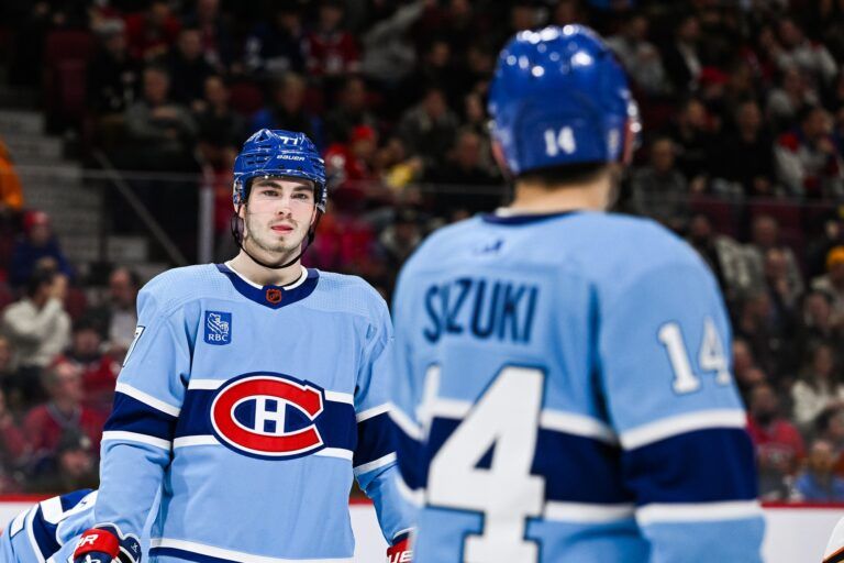 Montreal Canadiens center Kirby Dach (77) looks towards Montreal Canadiens center Nick Suzuki (14) prior to face-off against the Anaheim Ducks during the third period at Bell Centre.