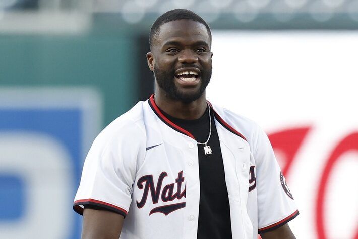 ATP world top ten men's singles tennis player Frances Tiafoe smiles after throwing out the ceremonial first pitch prior to the game between the Miami Marlins and Washington Nationals at Nationals Park.