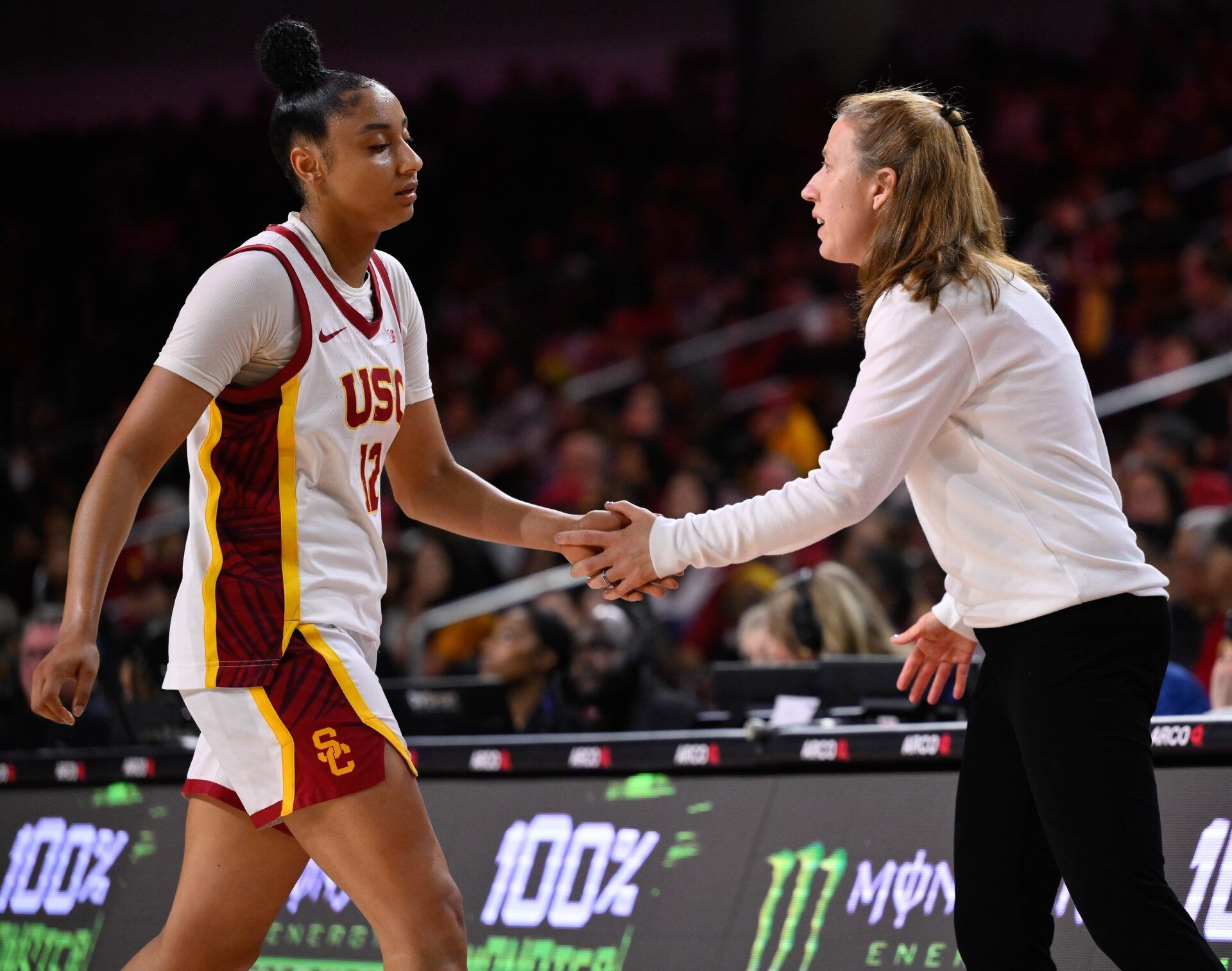 USC Trojans guard JuJu Watkins (12) slaps hands with USC Trojans head coach Lindsay Gottlieb was she comes out of the game in the fourth quarter against the Ohio State Buckeyes  at Galen Center.