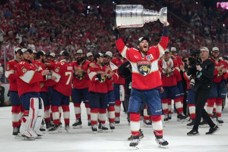 Florida Panthers left wing Matthew Tkachuk (19) hoist the Stanley Cup after game six of the 2025 Stanley Cup Final against the Edmonton Oilers at Amerant Bank Arena.