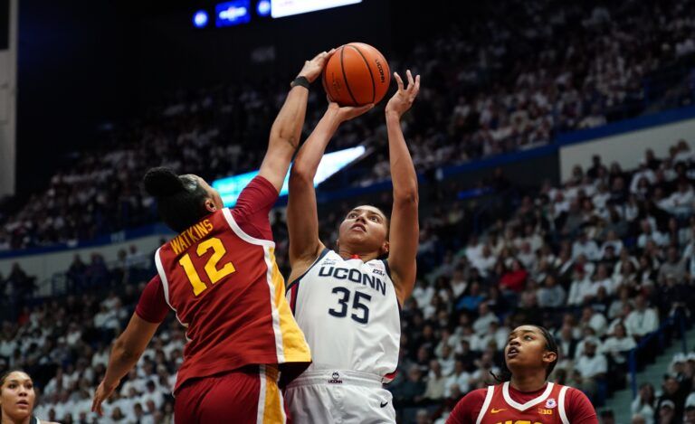 USC Trojans guard JuJu Watkins (12) blocks the shot of UConn Huskies guard Azzi Fudd (35) in the first half at XL Center.