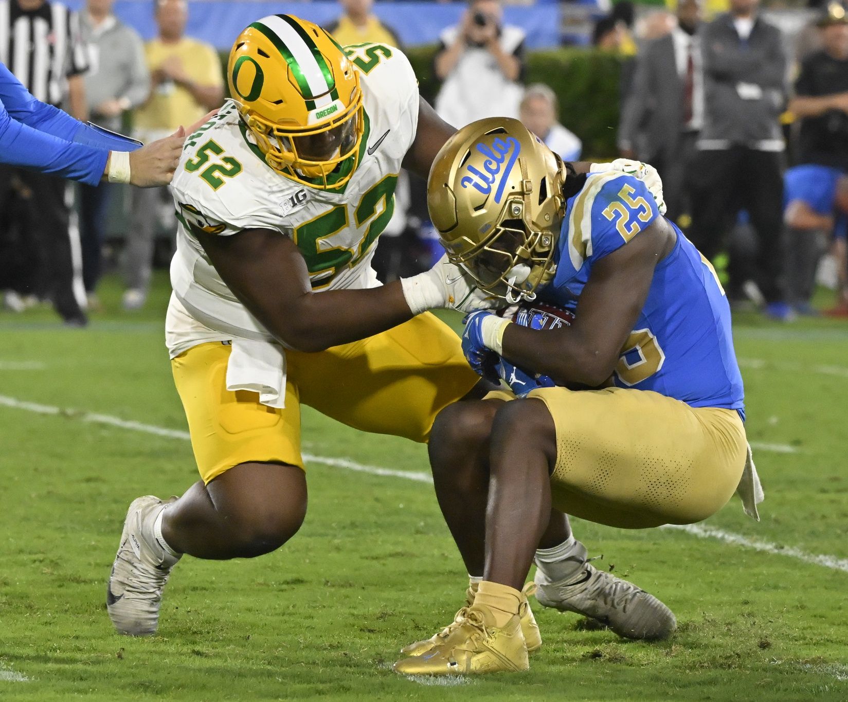 Oregon Ducks defensive lineman A'Mauri Washington (52) tackles UCLA Bruins running back T.J. Harden (25) in the backfield during the third quarter at Rose Bowl.
