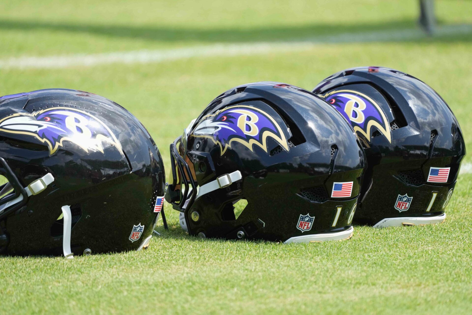 Baltimore Ravens helmets await use during training camp at the Under Armour Performance Center.