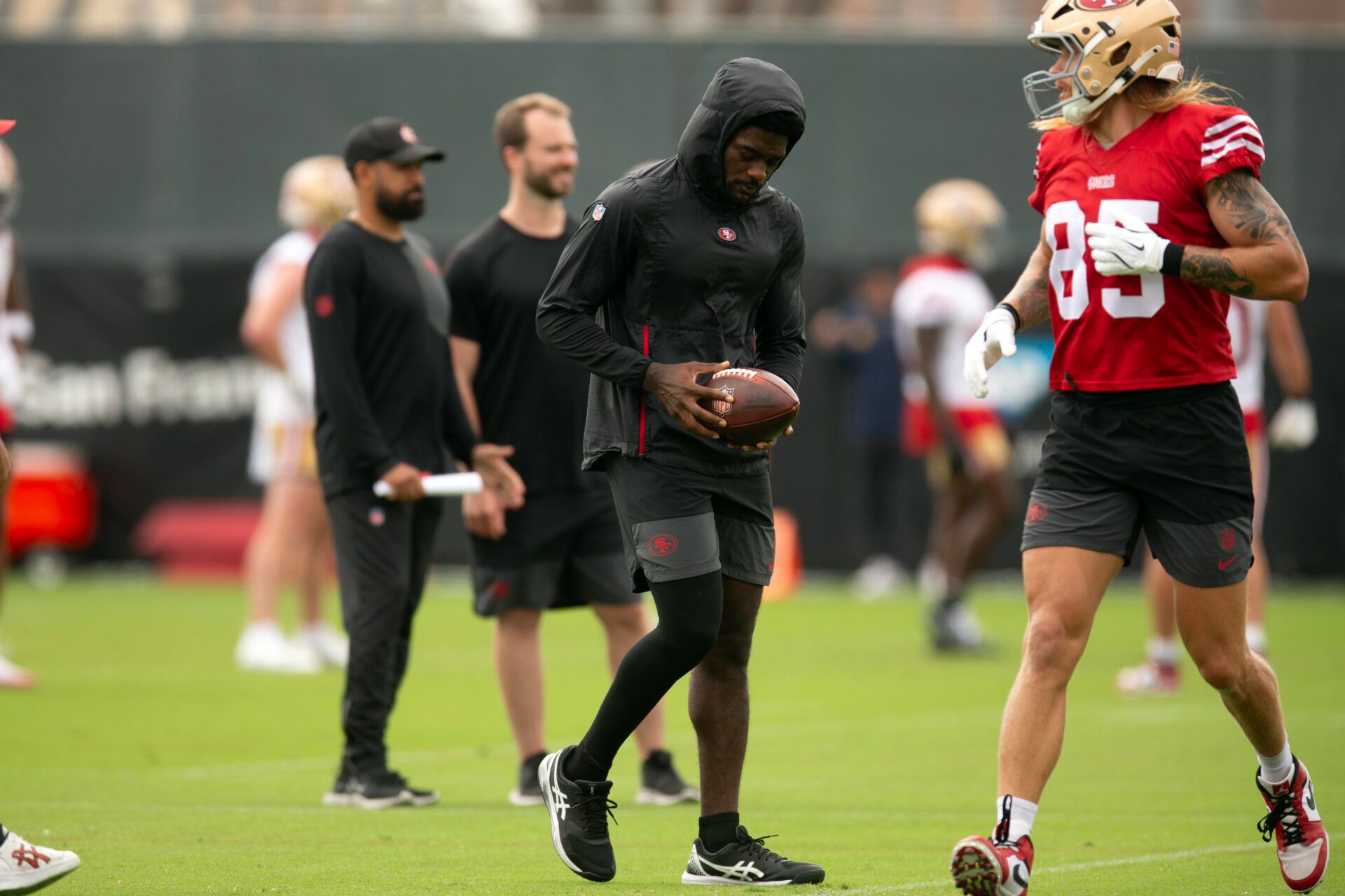 Still recovering from knee surgery, San Francisco 49ers wide receiver Brandon Aiyuk (left)  hangs out with teammate George Kittle (85) during the second day of training camp.
