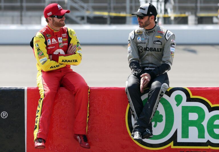 Sprint Cup Series driver Dale Earnhardt Jr. (left) talks with Sprint Cup Series driver Jimmie Johnson , right, prior to qualifying for the FireKeepers Casino 400 at Michigan International Speedway.