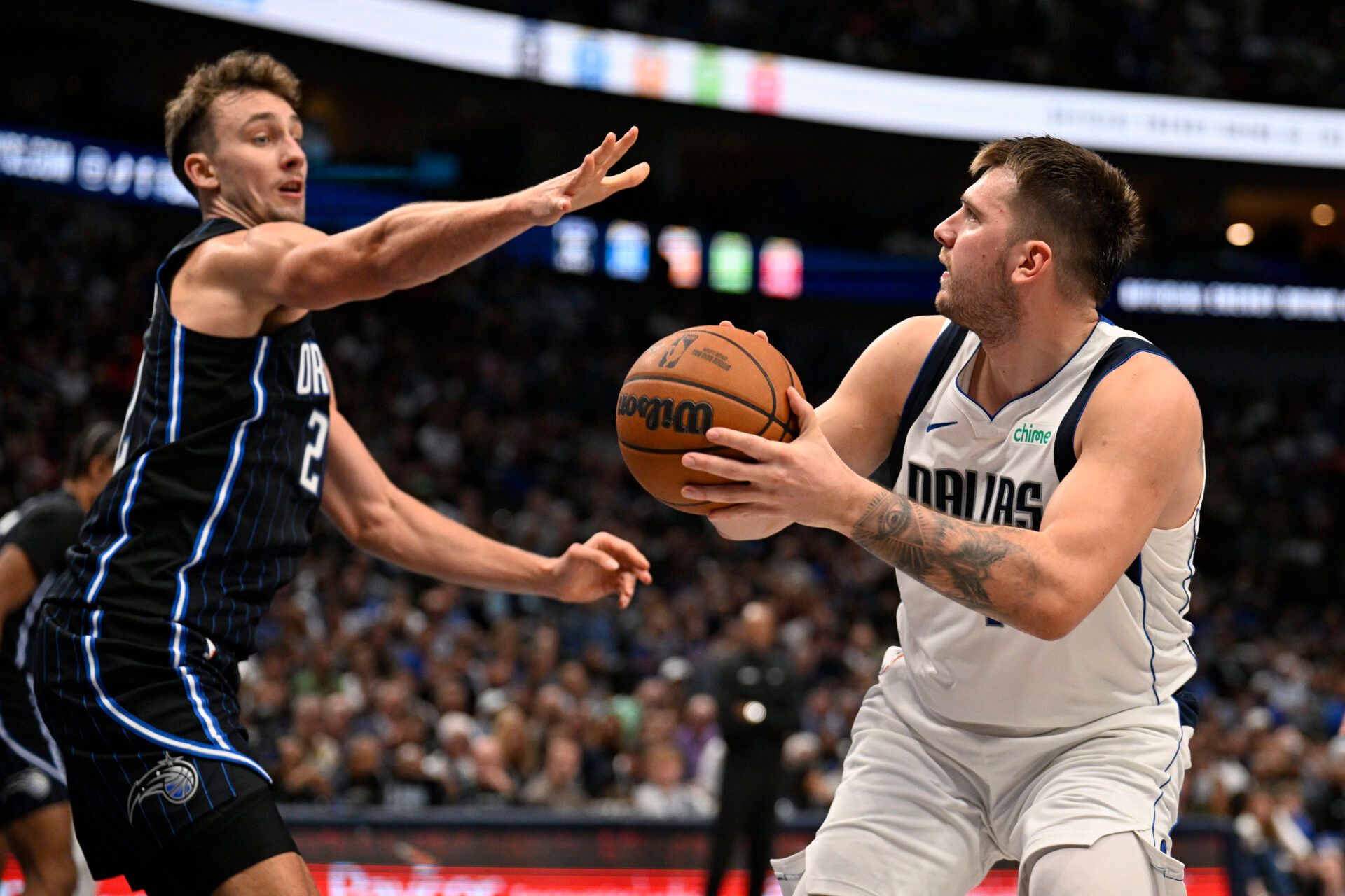 Dallas Mavericks guard Luka Doncic (77) shoots over Orlando Magic forward Franz Wagner (22) during the second quarter at the American Airlines Center.
